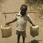 african boy fetching water